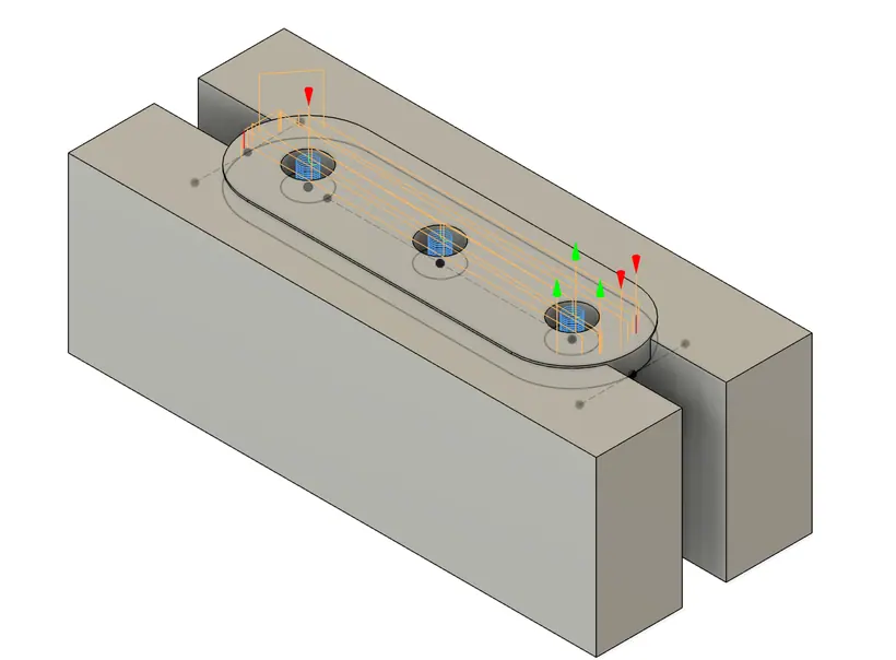 CAM setup for a conveyor chain link, the part seated between two stepped vise jaw blocks with drilling toolpaths shown.